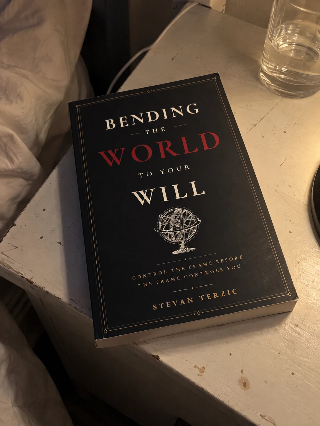 Illustrative scene: the paperback on a bedside table