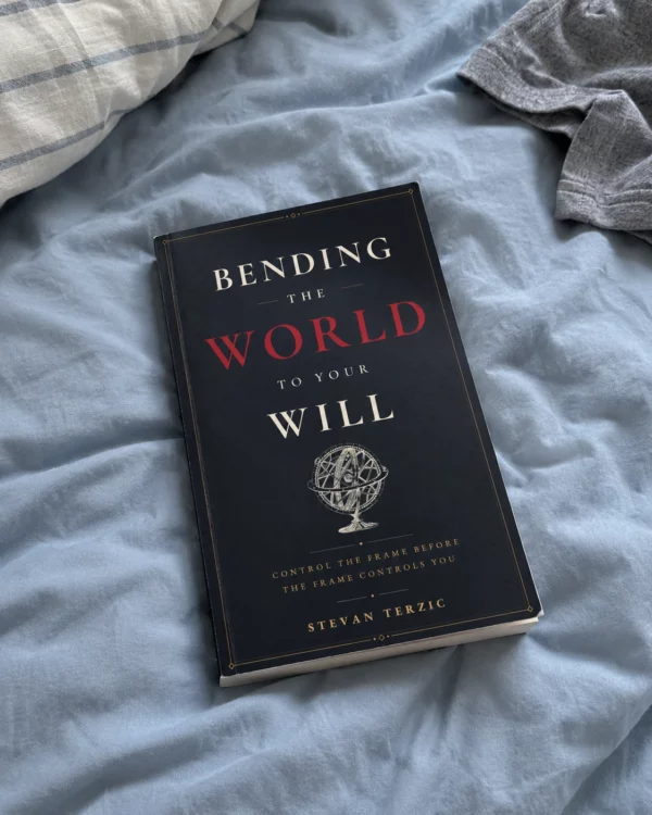 Illustrative scene: the paperback resting on a blue duvet